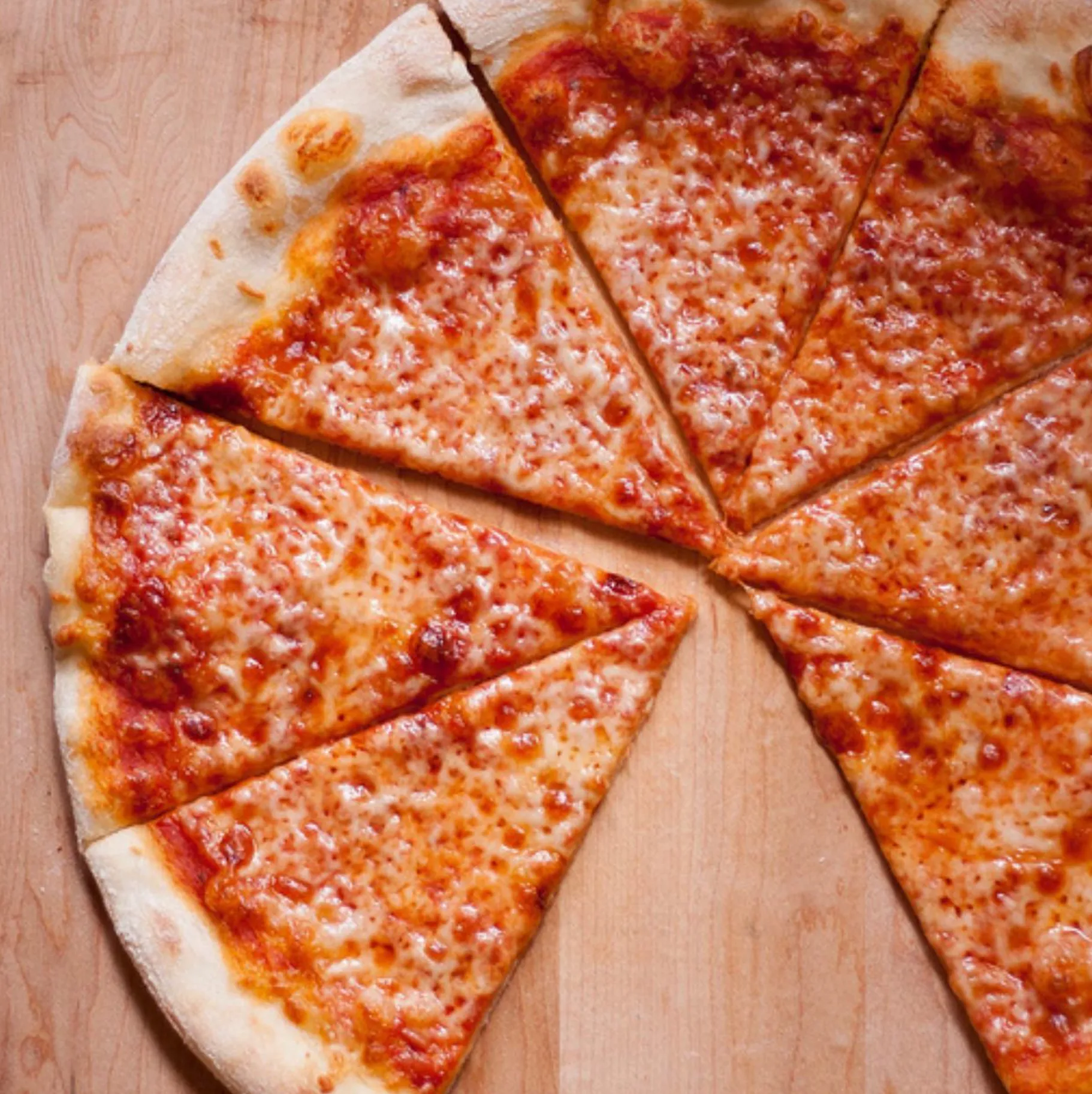 A classic New York cheese pizza, hand-cut into slices