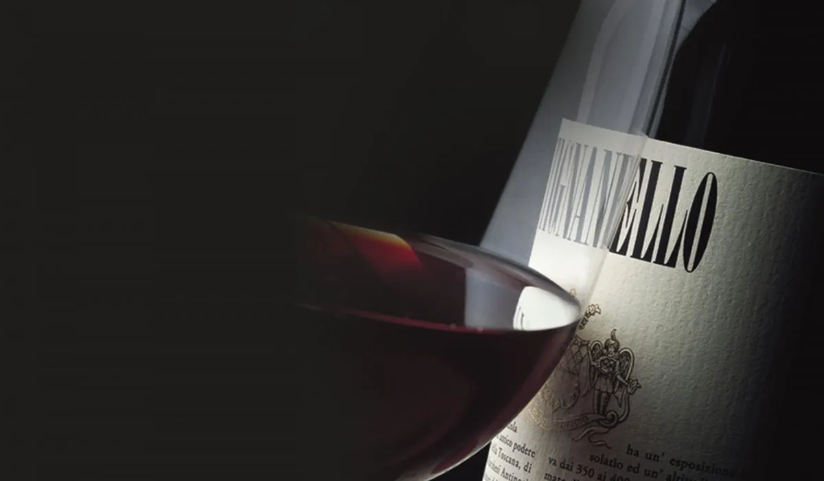 A glass of red wine in front of a Tignanello bottle